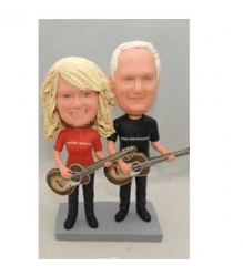 Parents playing guitar bobblehead cake toppers