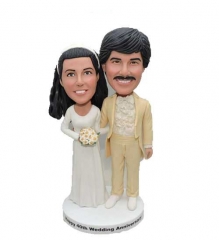 70s or 80s wedding couple bobbleheads cake toppers