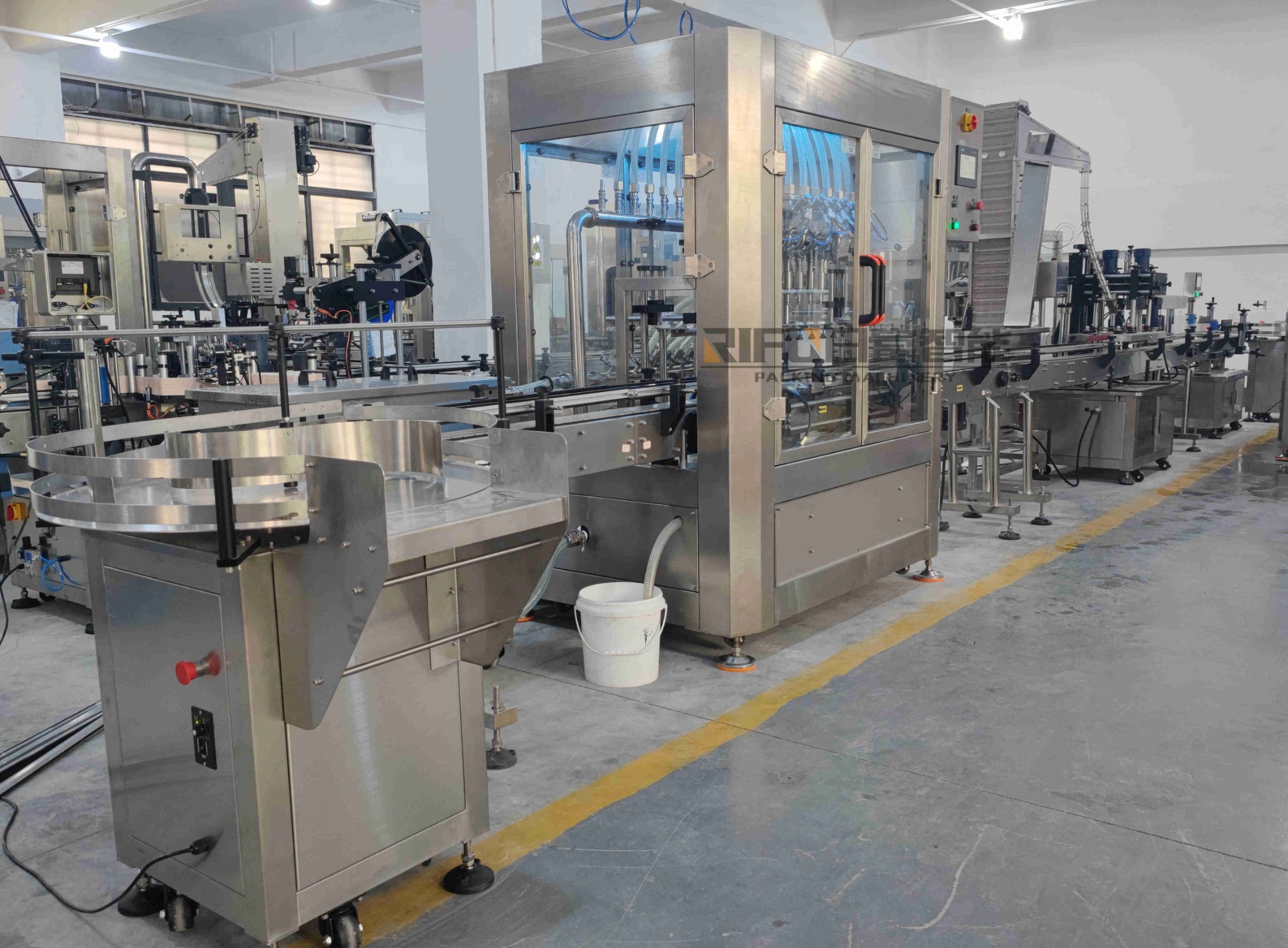 New Venezuela Customer Bought Liquid Overflow Filling Capping Labeling Packaging Line