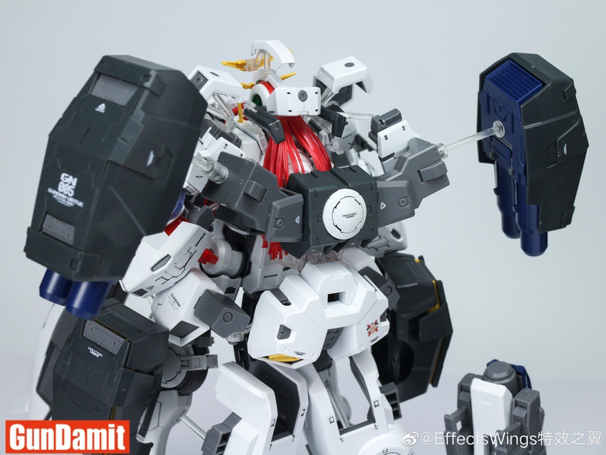 Upper body close-up of Gundam Virtue showing opened chest armor panels and dual GN Cannon mounts Upper body close-up of Gundam Virtue showing opened chest armor panels and dual GN Cannon mounts
