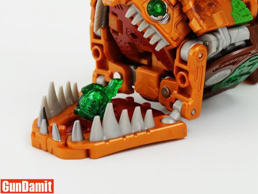 Close-up of Rustypiece jaw mechanism with green translucent crystal piece inside mouth Close-up of Rustypiece jaw mechanism with green translucent crystal piece inside mouth