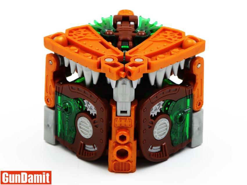 BB-42 Rustypiece in compact cube box mode with mechanical teeth and green internal gears visible BB-42 Rustypiece in compact cube box mode with mechanical teeth and green internal gears visible