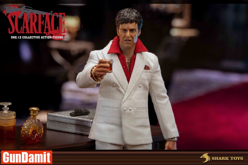 Tony Montana action figure holding whiskey glass at mahogany desk Tony Montana action figure holding whiskey glass at mahogany desk