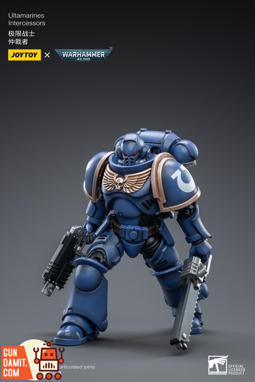 JoyToy Ultramarines Intercessor front view in blue power armor with bolt rifle and chainsword JoyToy Ultramarines Intercessor front view in blue power armor with bolt rifle and chainsword