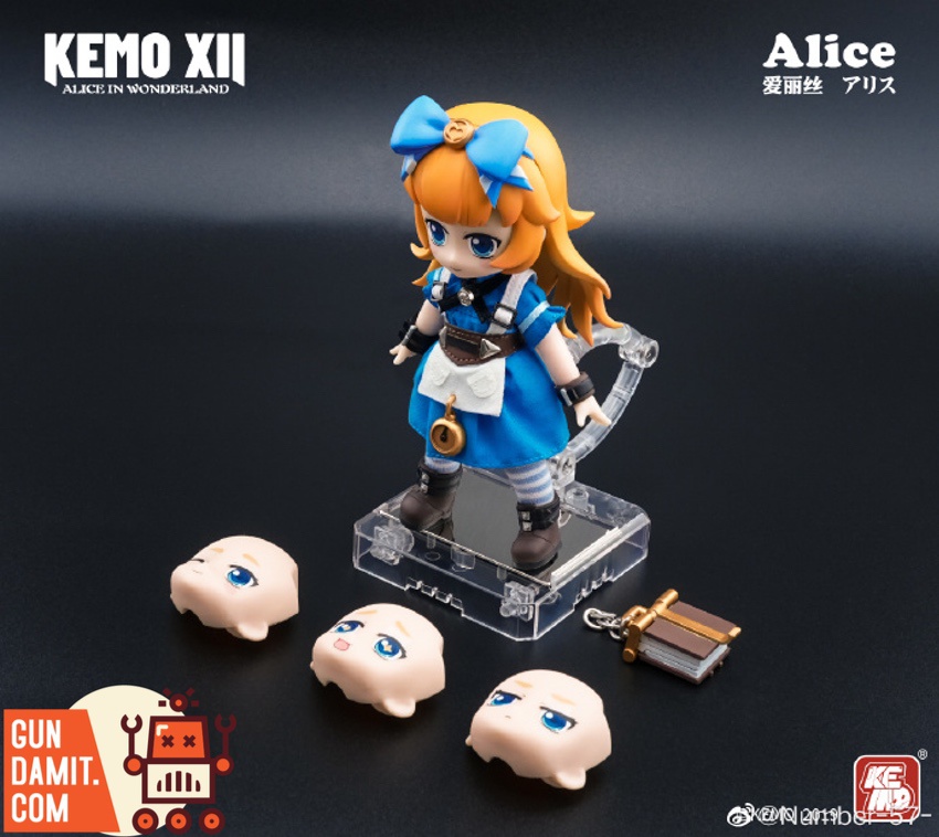 Kemo XII Doll Alice in Wonderland Alice front view with three face plates and key accessory on display stand Kemo XII Doll Alice in Wonderland Alice front view with three face plates and key accessory on display stand