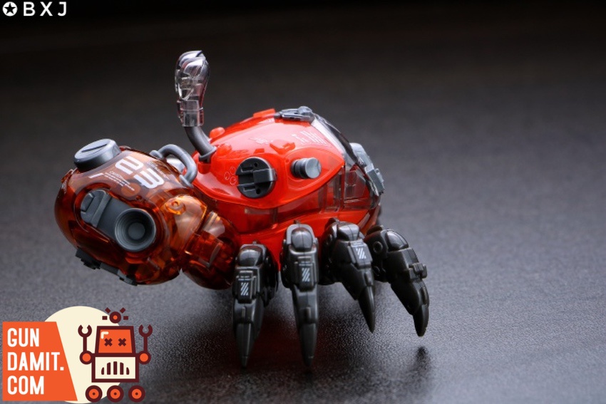 Red fiddler crab model rear three-quarter angle on dark surface Red fiddler crab model rear three-quarter angle on dark surface