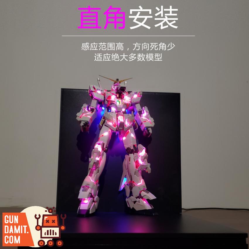 GOMO wireless LED lighting illuminating Unicorn Gundam with pink and blue glow GOMO wireless LED lighting illuminating Unicorn Gundam with pink and blue glow