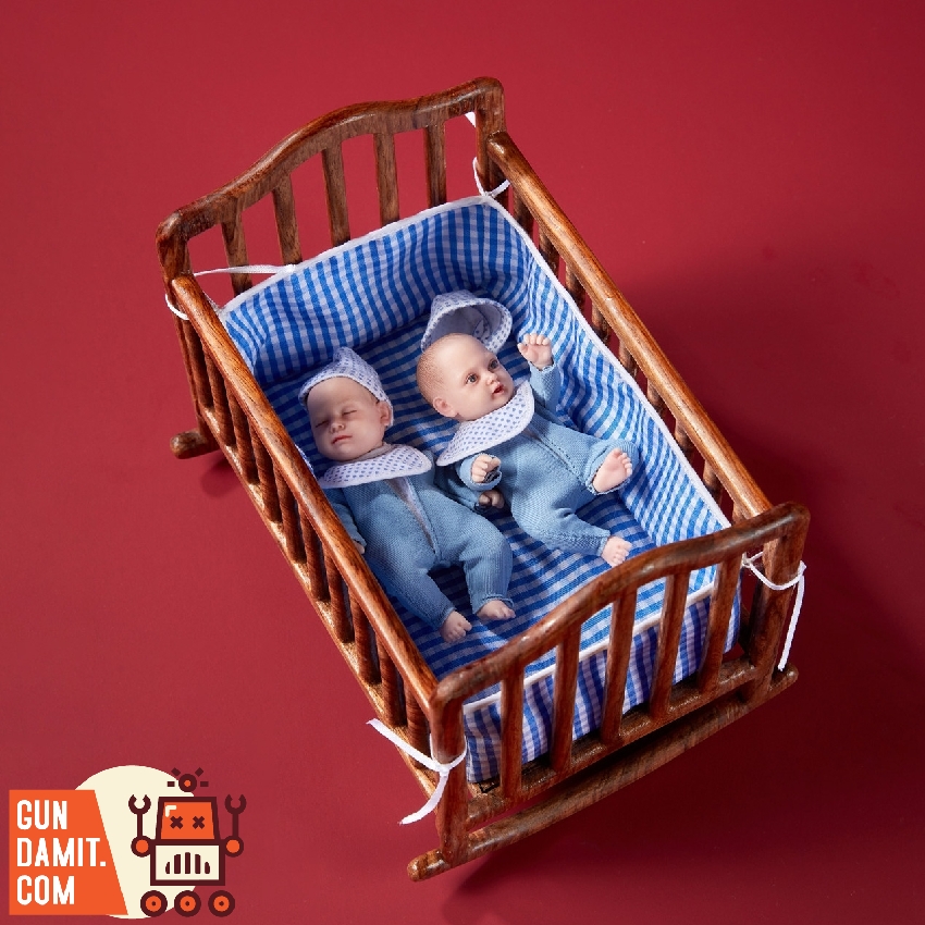 ADD Toys AD-012B baby figure in blue knitted outfit sitting beside crib ADD Toys AD-012B baby figure in blue knitted outfit sitting beside crib