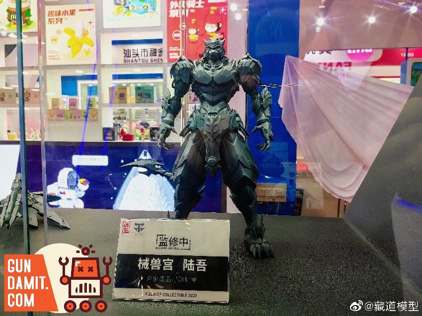 CangDao Mecha Beast Lu Wu grey prototype figure at toy show booth showing full armored beast design CangDao Mecha Beast Lu Wu grey prototype figure at toy show booth showing full armored beast design