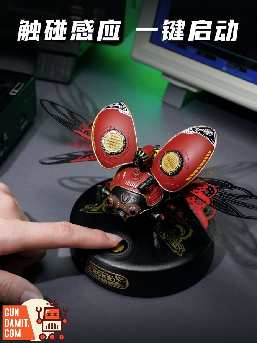 Scout Beetle with wings open on desk showing touch-activated base and red wing illumination Scout Beetle with wings open on desk showing touch-activated base and red wing illumination
