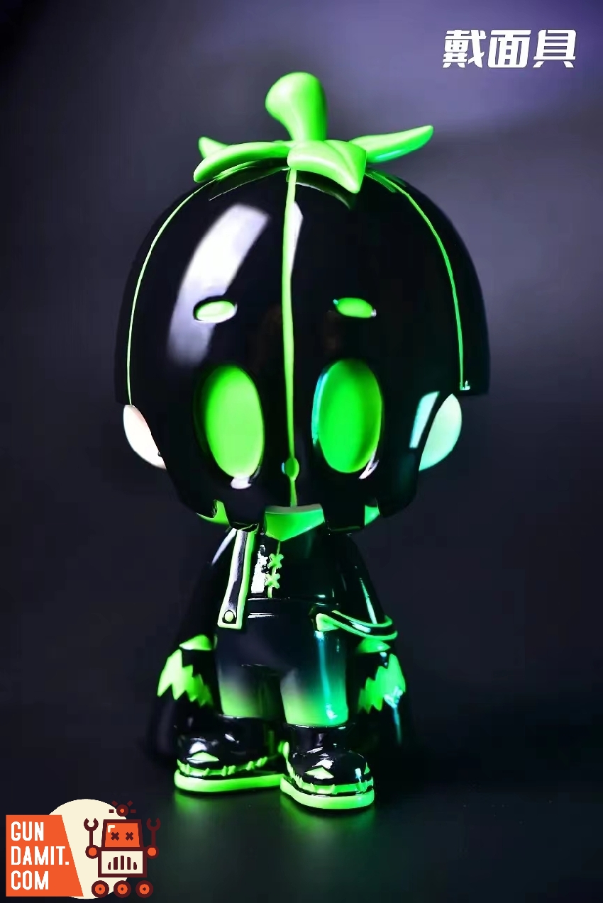 Dico luminous figure wearing green glowing pumpkin mask with leaf stem on dark background Dico luminous figure wearing green glowing pumpkin mask with leaf stem on dark background