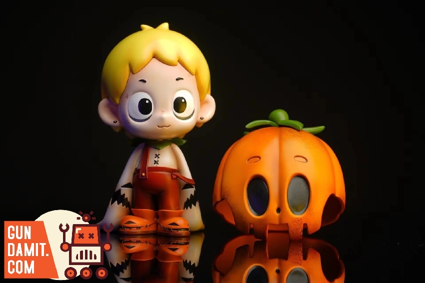 Both Dico figures displayed together showing original pumpkin version and luminous painted companion Both Dico figures displayed together showing original pumpkin version and luminous painted companion
