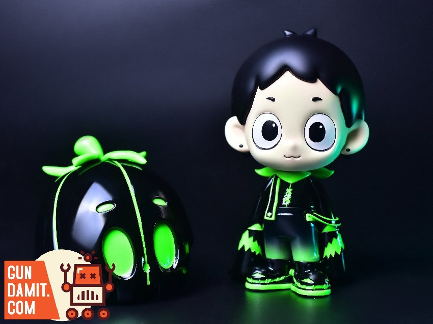 Side-by-side view of Dico luminous figure and green glowing pumpkin head mask Side-by-side view of Dico luminous figure and green glowing pumpkin head mask