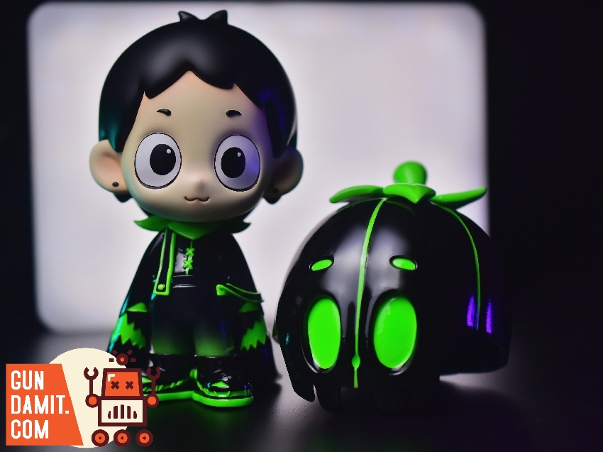 Luminous painted Dico figure with black and green neon color scheme alongside glowing pumpkin head Luminous painted Dico figure with black and green neon color scheme alongside glowing pumpkin head
