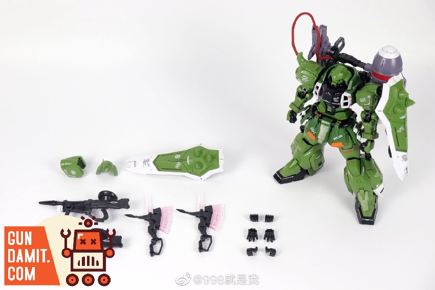 Gunner Zaku Warrior side profile showing heavy cannon backpack and green armor with orange details Gunner Zaku Warrior side profile showing heavy cannon backpack and green armor with orange details