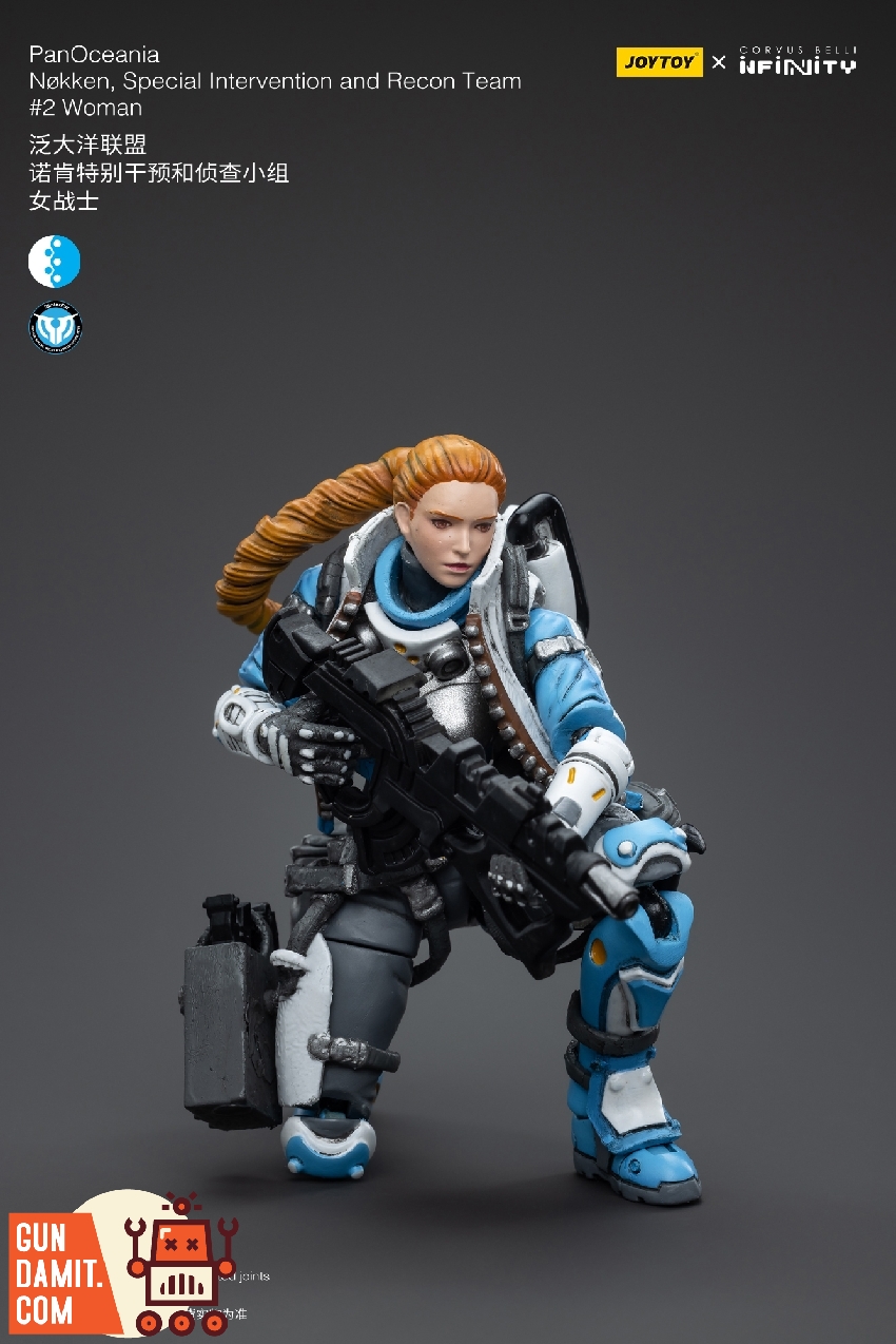 Nokken Recon Team woman in crouching tactical pose with rifle at ready and supply case at hip Nokken Recon Team woman in crouching tactical pose with rifle at ready and supply case at hip