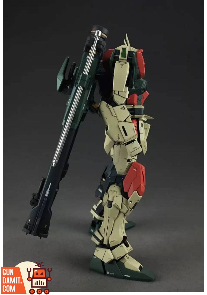 Side profile of Buster Gundam holding high energy rifle showing tan and dark green armor plating Side profile of Buster Gundam holding high energy rifle showing tan and dark green armor plating