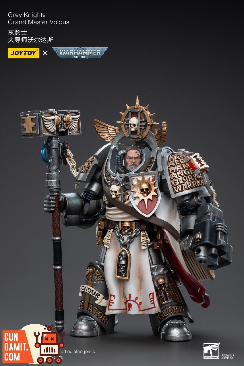 Full front standing view of Grand Master Voldus with Daemon Hammer at rest and storm bolter mounted on arm Full front standing view of Grand Master Voldus with Daemon Hammer at rest and storm bolter mounted on arm