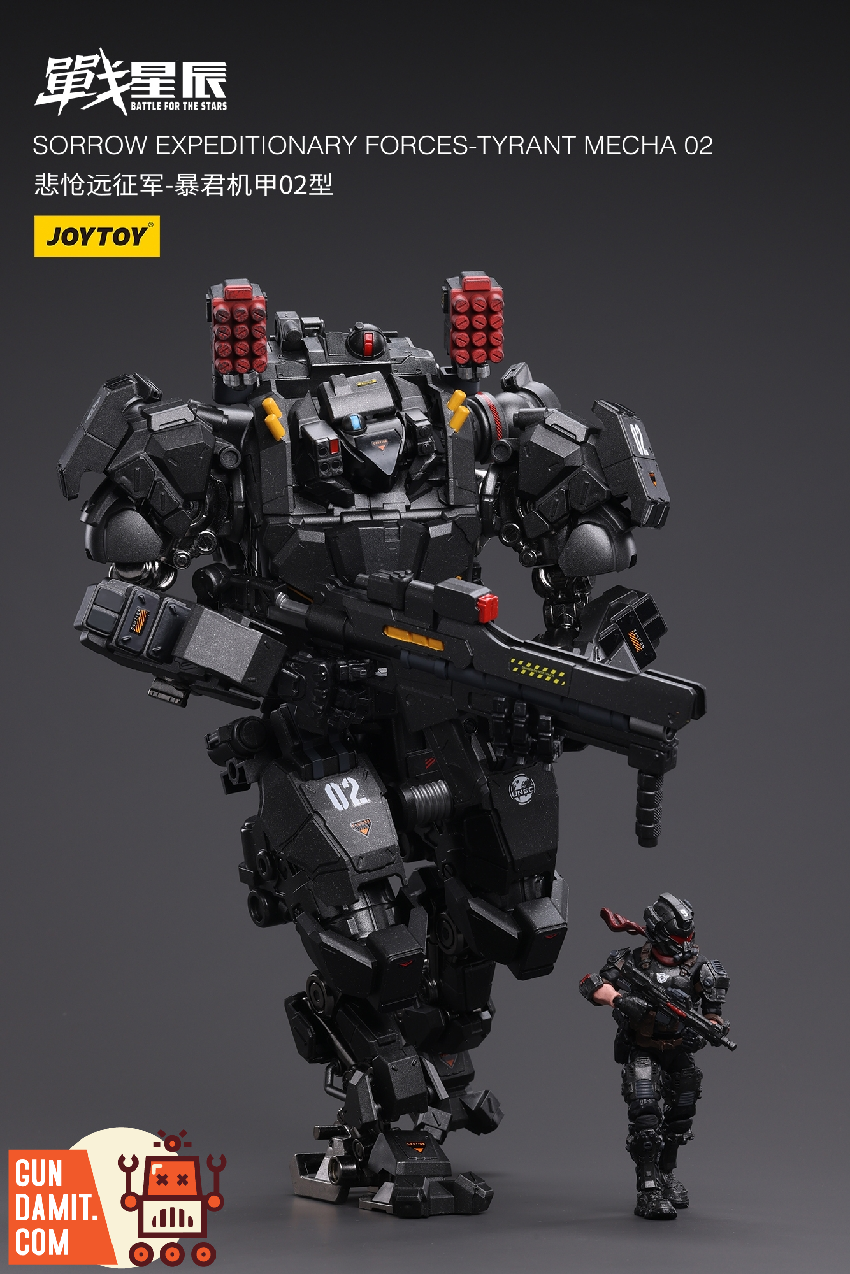 Tyrant Mecha 02 standing with pilot figure for scale comparison showing massive dark armored walker Tyrant Mecha 02 standing with pilot figure for scale comparison showing massive dark armored walker