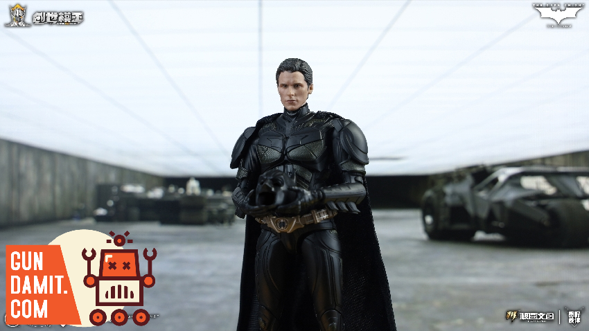 Bruce Wayne unmasked in black Batsuit holding cowl with Batmobile visible in background Bruce Wayne unmasked in black Batsuit holding cowl with Batmobile visible in background