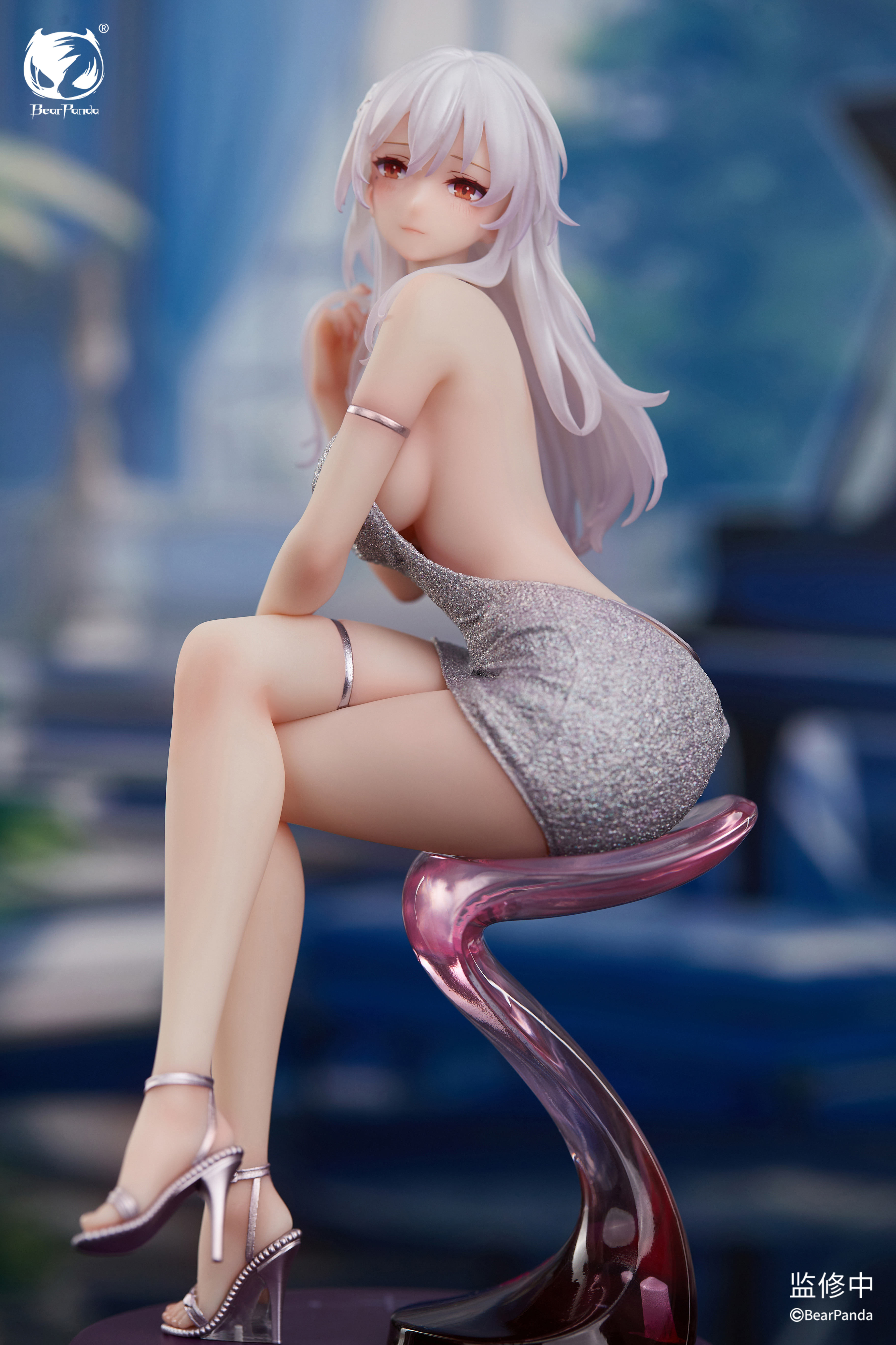 Side profile of Serina looking over shoulder showing backless dress design and pink translucent stool base Side profile of Serina looking over shoulder showing backless dress design and pink translucent stool base