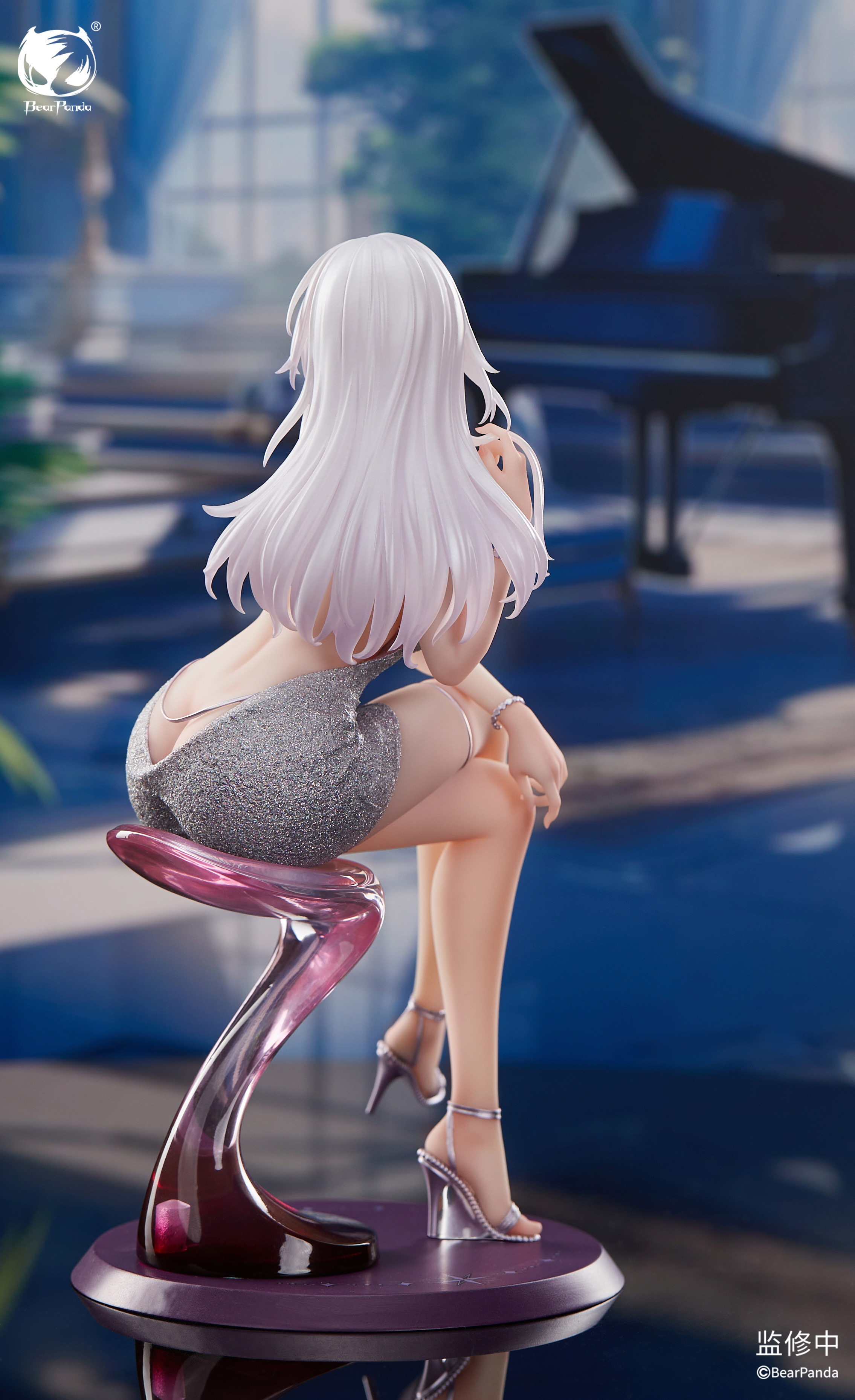 Rear view of Serina on bar stool showing flowing white hair and silver dress against piano room backdrop Rear view of Serina on bar stool showing flowing white hair and silver dress against piano room backdrop