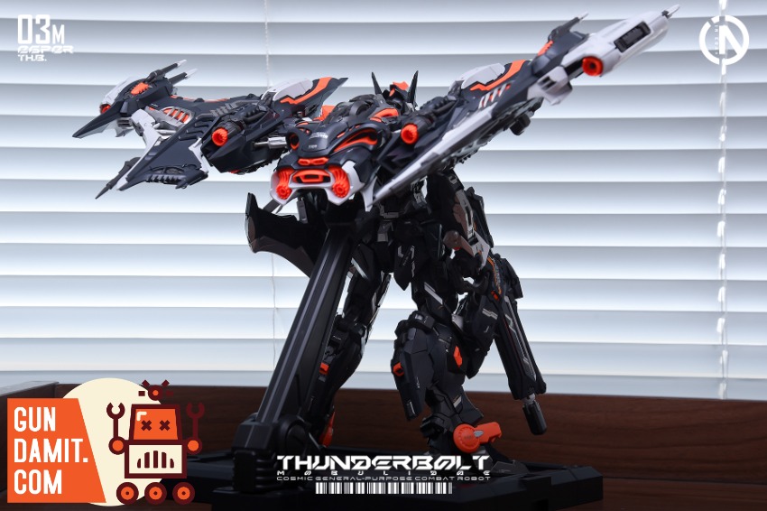 IN ERA+ 1/100 RMD Series Thunderbolt Manta Ray Speed Version A detailed black and orange robot model stands on a wooden surfa IN ERA+ 1/100 RMD Series Thunderbolt Manta Ray Speed Version A detailed black and orange robot model stands on a wooden surfa