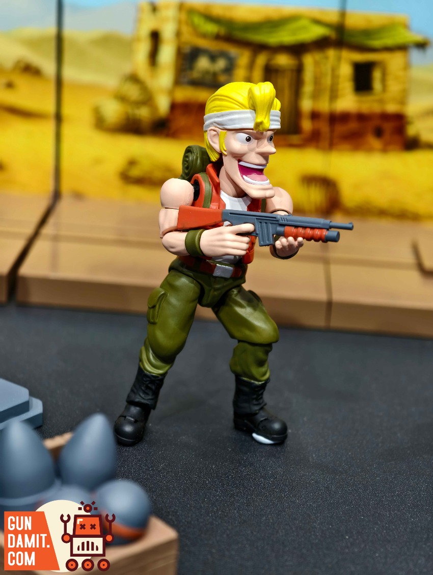 YoloPark AMK MINl Pro Series Metal Slug 3 Wave 1 Model Kit Action figure with yellow hair, red gun, green pants, black boots. YoloPark AMK MINl Pro Series Metal Slug 3 Wave 1 Model Kit Action figure with yellow hair, red gun, green pants, black boots.