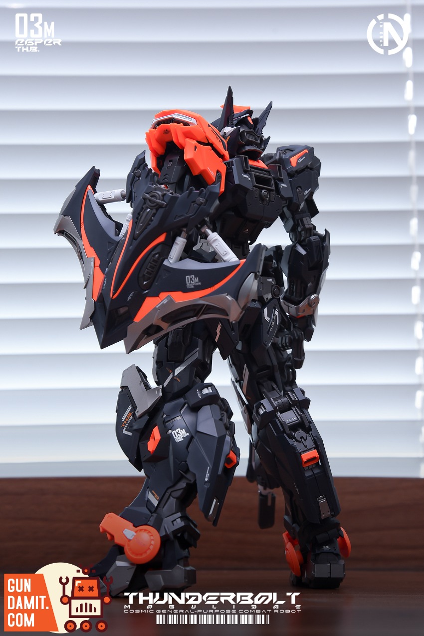 IN ERA+ 1/100 RMD Series Thunderbolt Manta Ray Speed Version A detailed black and orange robot model kit stands against a win IN ERA+ 1/100 RMD Series Thunderbolt Manta Ray Speed Version A detailed black and orange robot model kit stands against a win