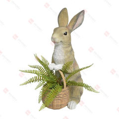 RESIN BUNNY HOLDING BASKET WITH ARTIFICIAL TAXIFOLIA INSIDE