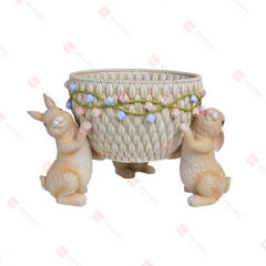 RESIN BUNNIES HOLDING
A BASKET