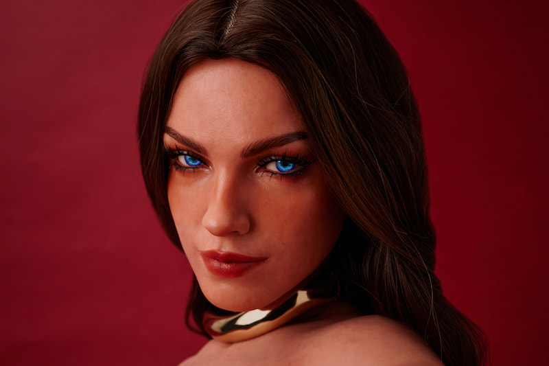 ULW 663# Emma: This close-up facial view highlights the doll's detailed makeup, featuring striking blue eyes, thick lashes, and defined red lips, beautifully framed by her long center-parted dark wavy hair and a metallic gold choker against a red background.