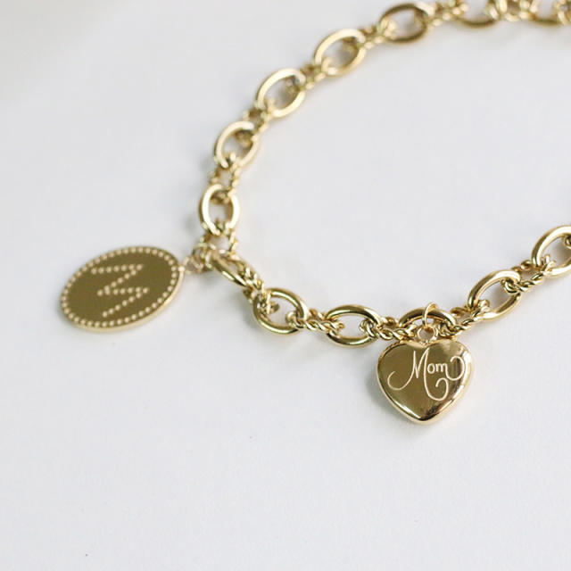 Link chain bracelet with engraved charm