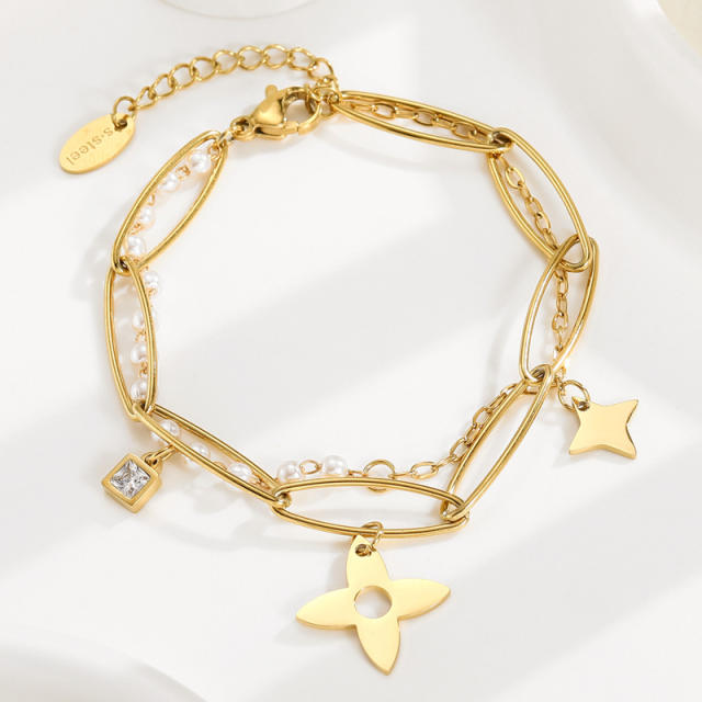 Stainless steel clover charm in pearl bracelet