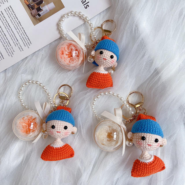 Girl with hand woven pearl earrings keychain
