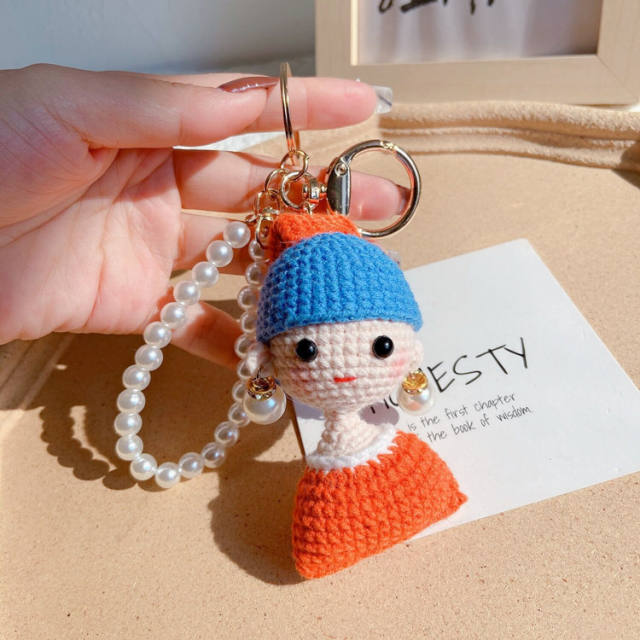 Girl with hand woven pearl earrings keychain