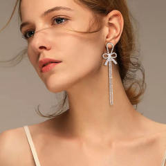 Diamond bow tassel dangle earrings