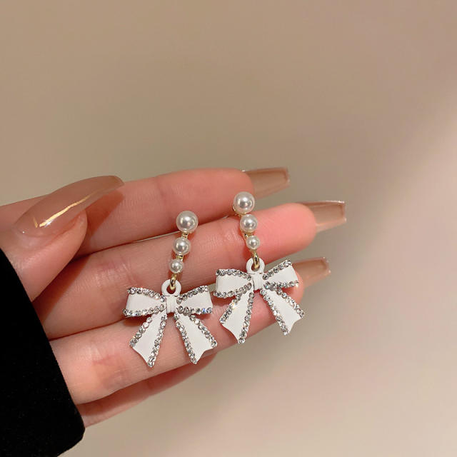 Diamond bow pearl earrings