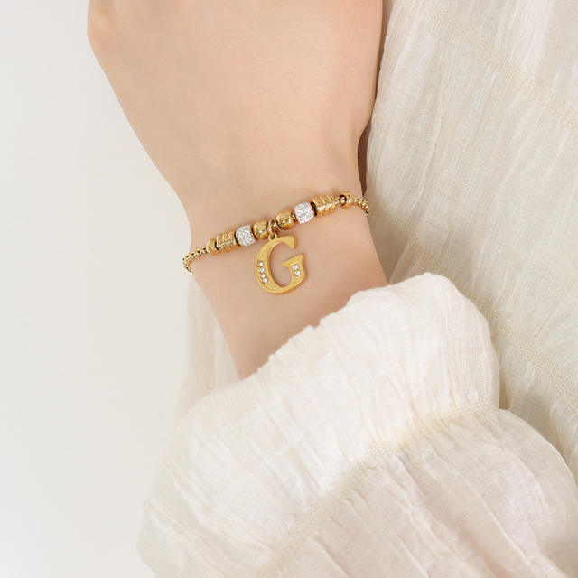 Delicate initial charm stainless steel slide bracelet