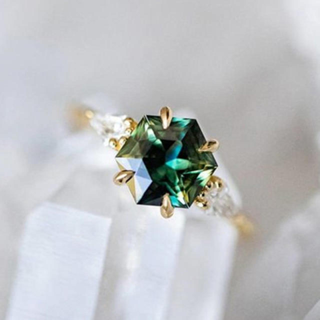 Elegant gold color emerald statement halo rings