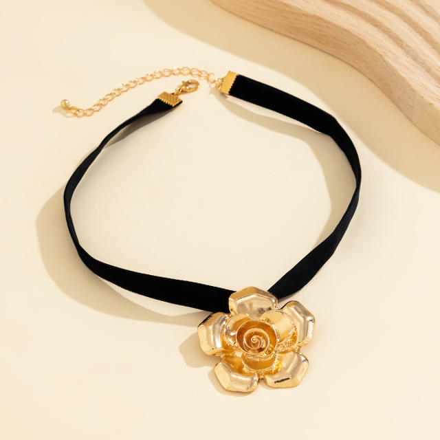 Vintage black velvet choker necklace with metal flower pendant