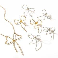18KG hot sale hollow out bow stainless steel necklace earrings set