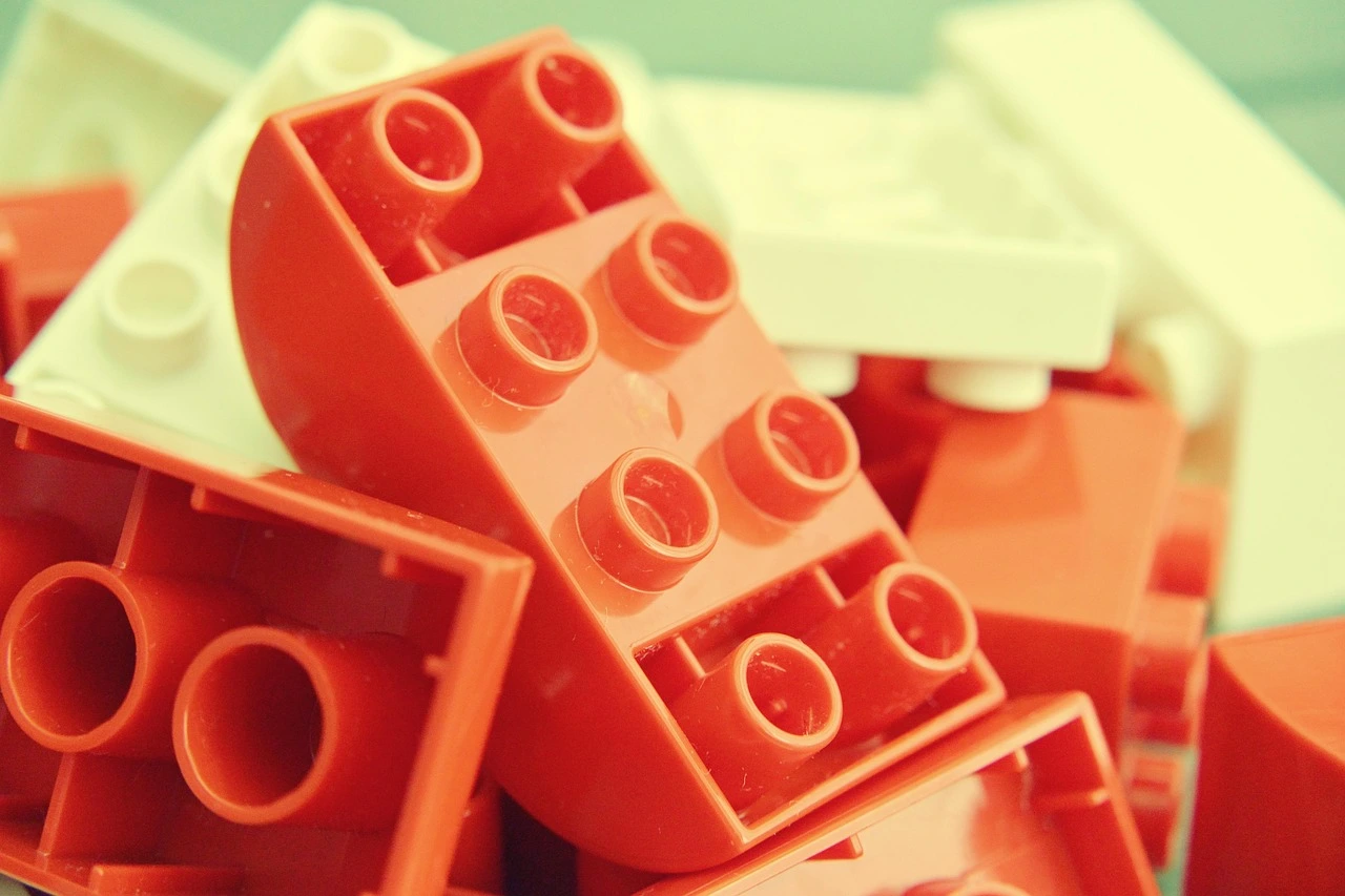 Red and orange building blocks piled up together.
