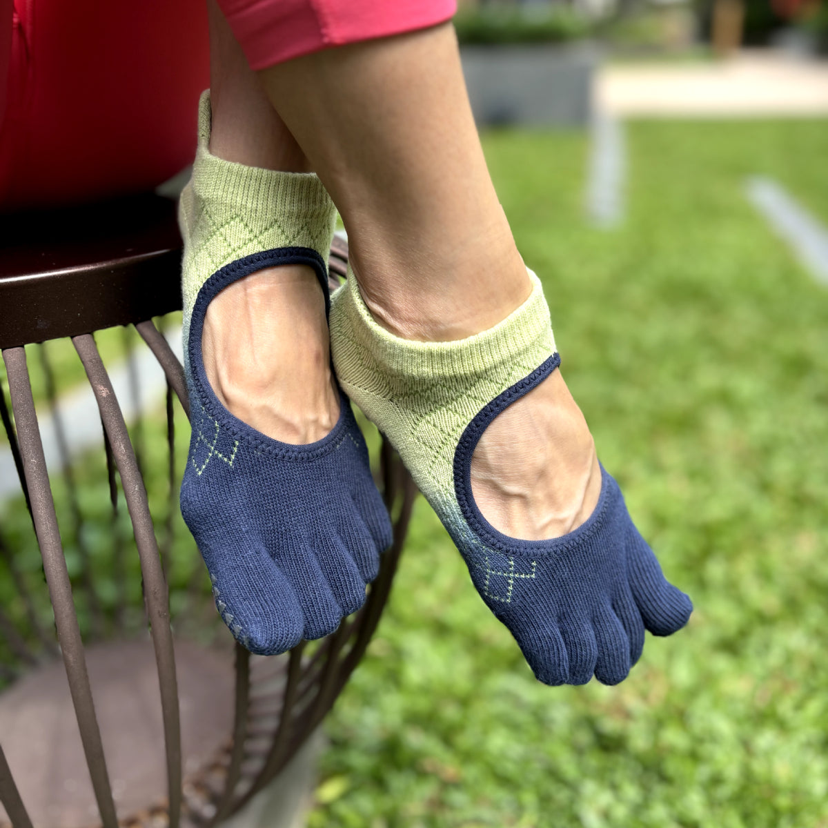 five-toe grip socks worn on feet showing separated toe design and fabric fit in an outdoor setting