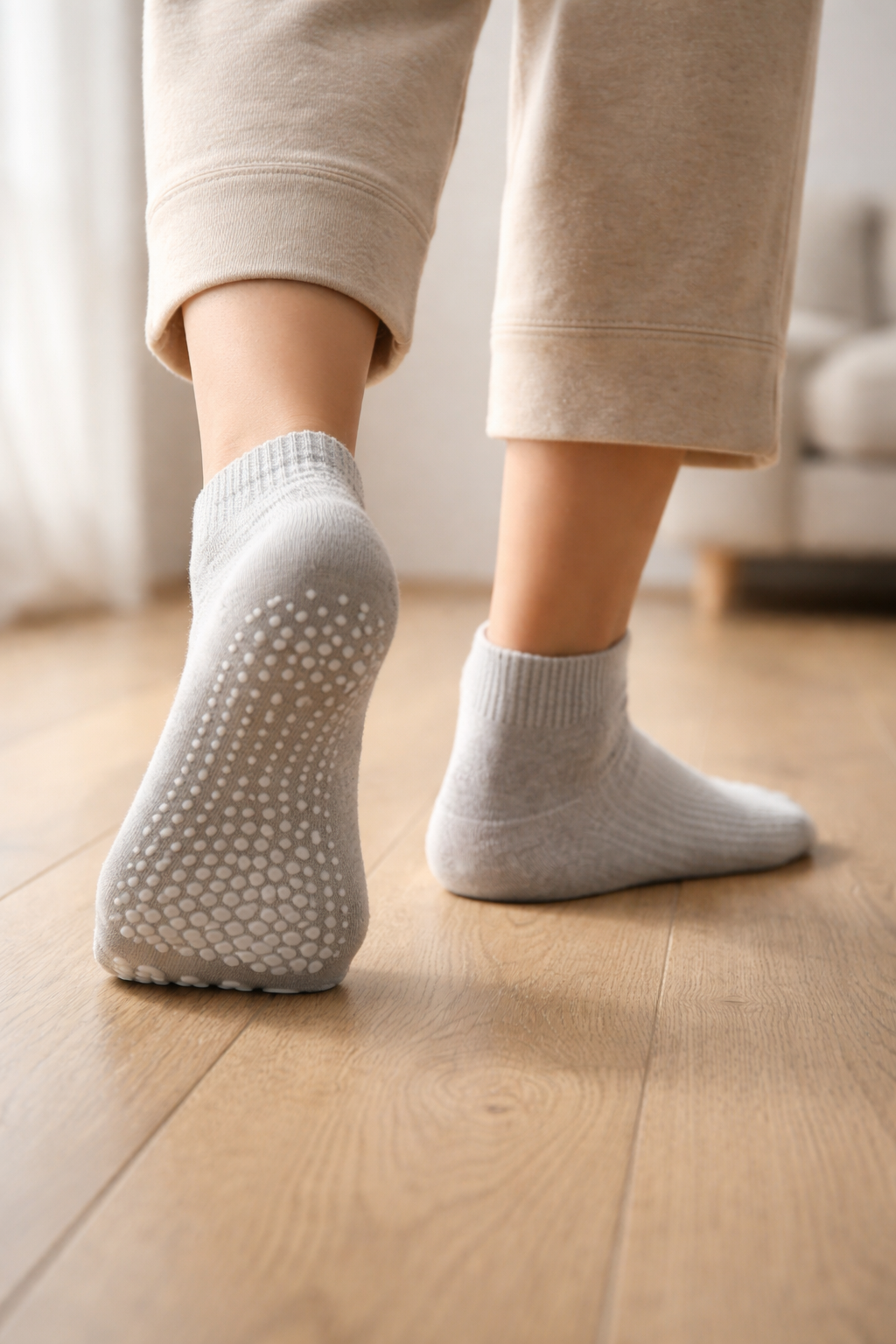 Close-up of grip socks sole with silicone traction dots, illustrating anti-slip design that improves grip on smooth indoor floors.