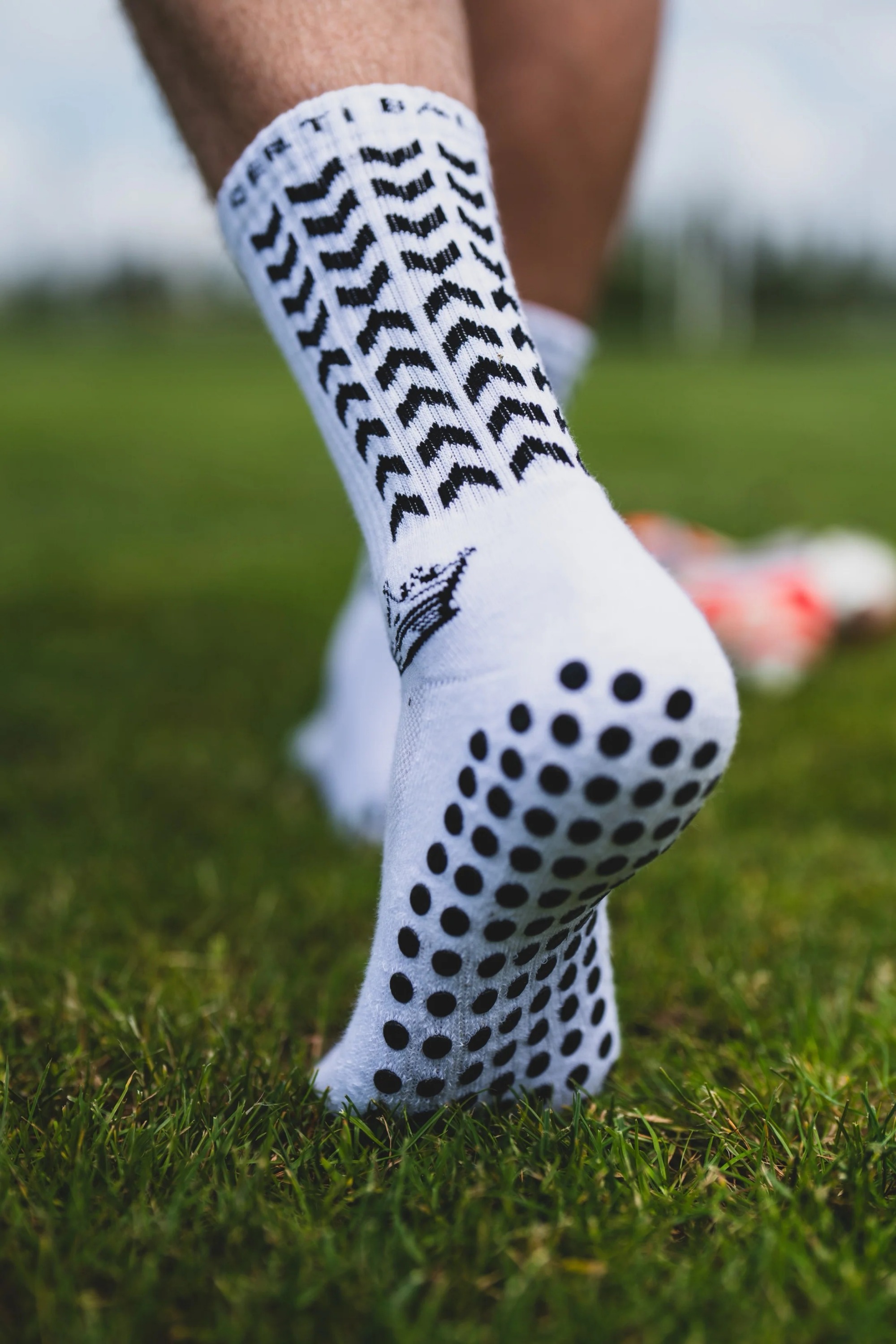 Grip socks with silicone dot traction pattern showing contact behavior under partial foot loading