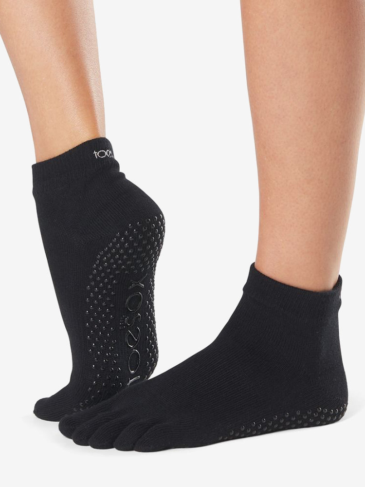 black five toe grip socks with silicone traction dots covering the sole for indoor stability