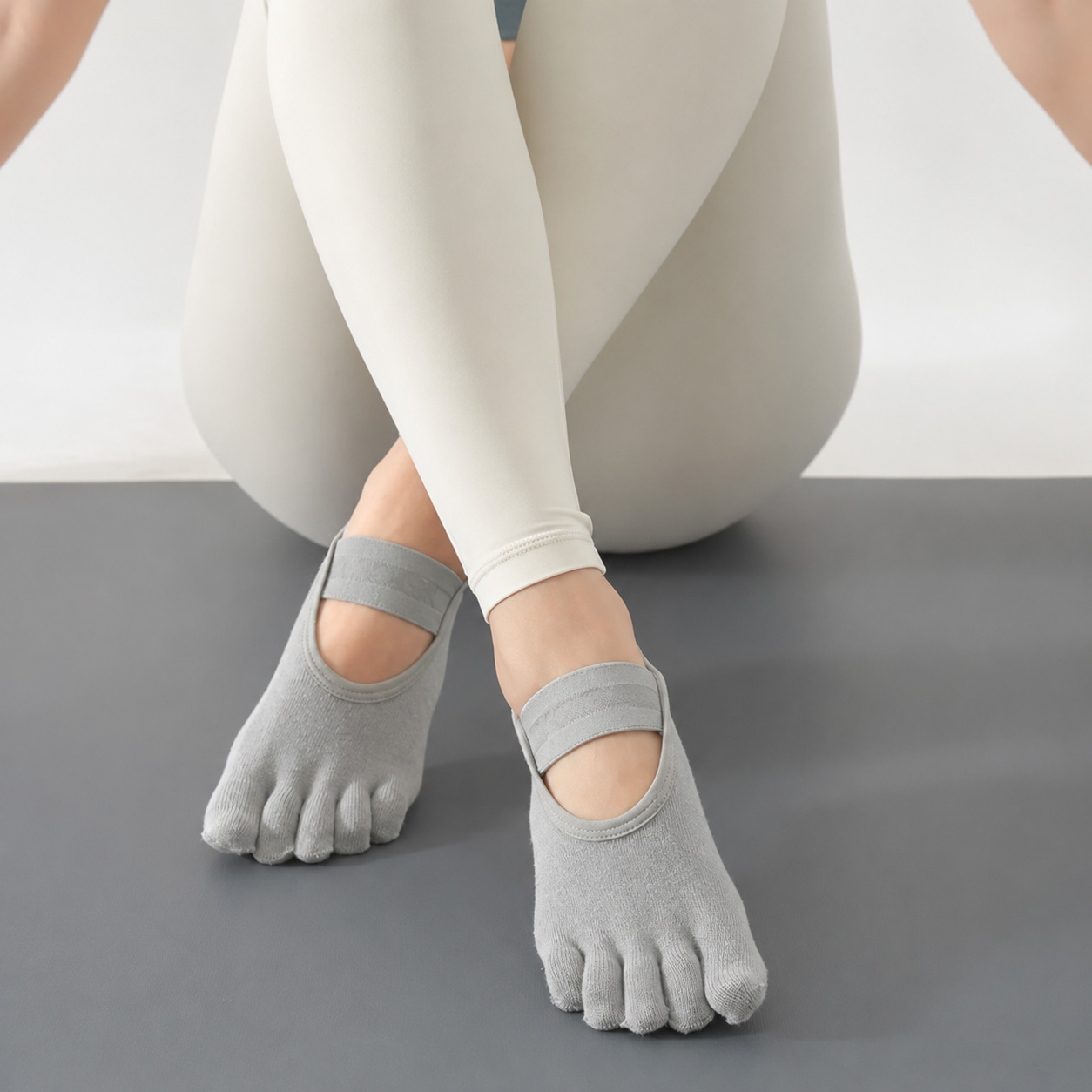 Custom five toe Pilates studio grip socks for reformer and barre classes, non-slip yoga socks with elastic strap manufactured by Yuintal