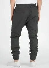 Back view of ItalyMorn men's dark grey green jogger pants on a model, highlighting the well-tailored seat, secure back pockets, and comfortable ribbed ankle cuffs