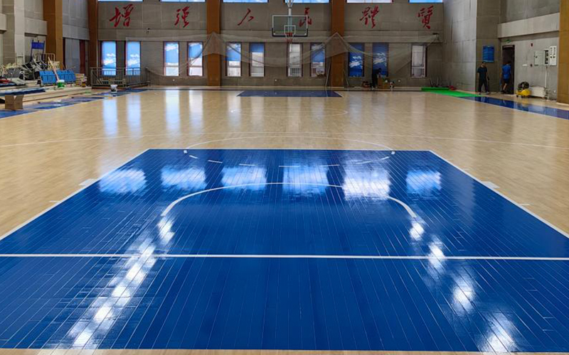 What are the floors of most indoor basketball courts made of?